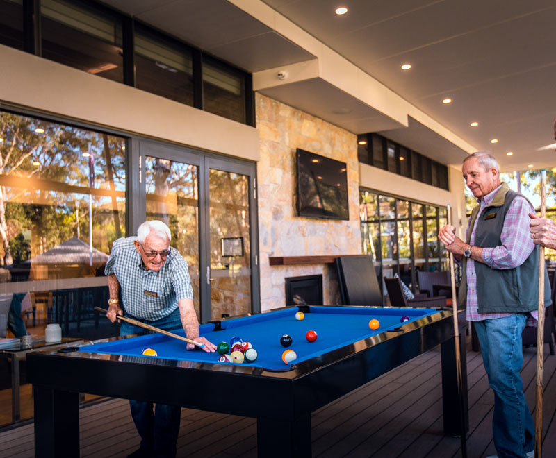 mens-group-playing-billiards-in-shores-club
